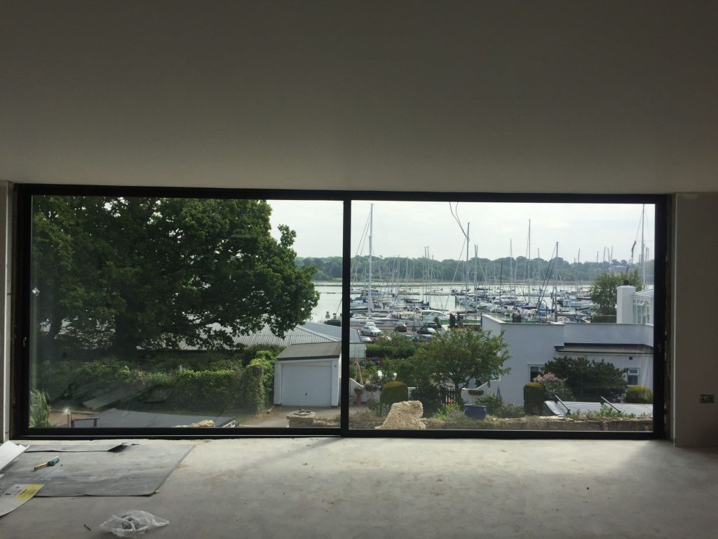 Large glass windows with a view of boats